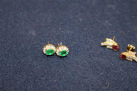 A pair of 14ct gold, emerald and diamond earrings and a pair of 18ct gold, ruby and diamond earrings